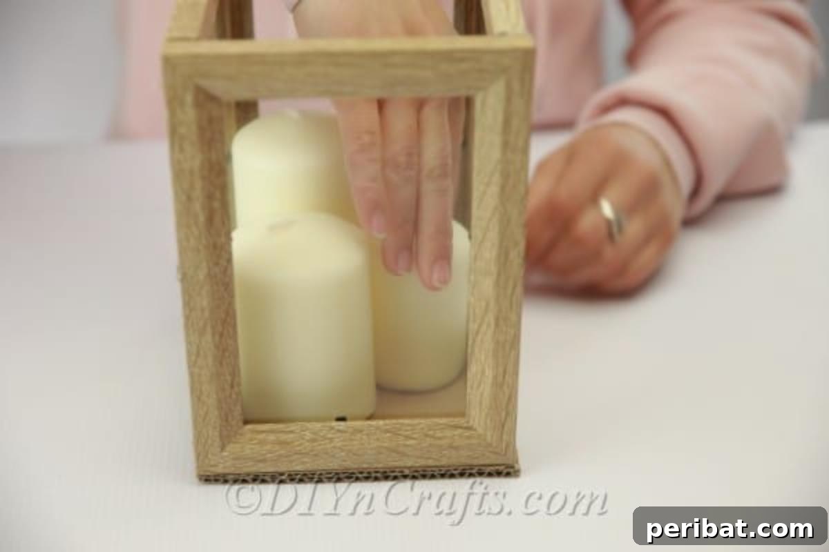 Adding seashells and candles to picture frame lantern for final look