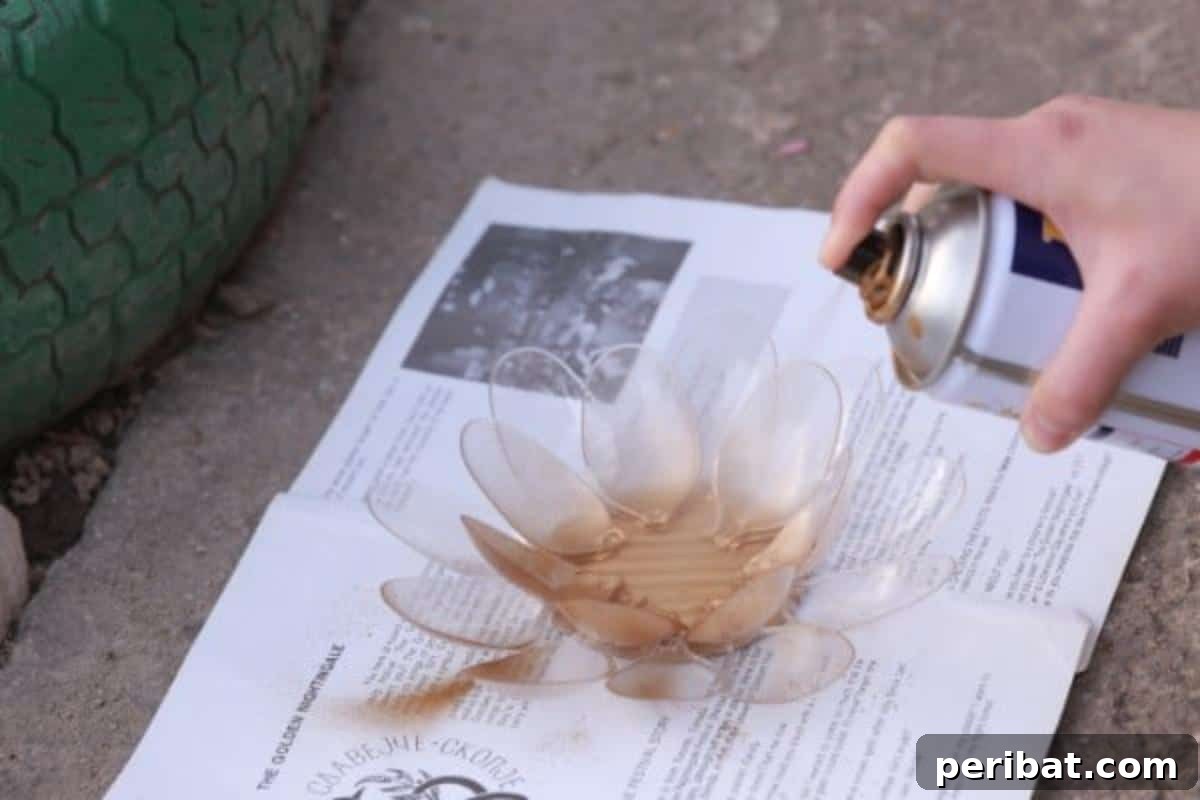 Spray painting the base of the plastic spoon candle holder a vibrant color