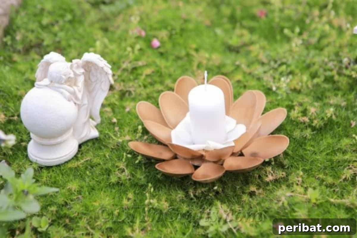 Finished DIY candle holder made from repurposed plastic spoons, illuminated