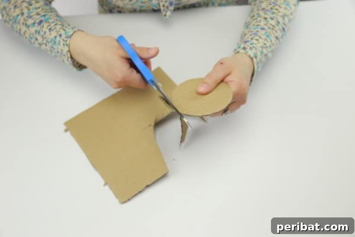 Cutting the cardboard into a circle for the candle holder project