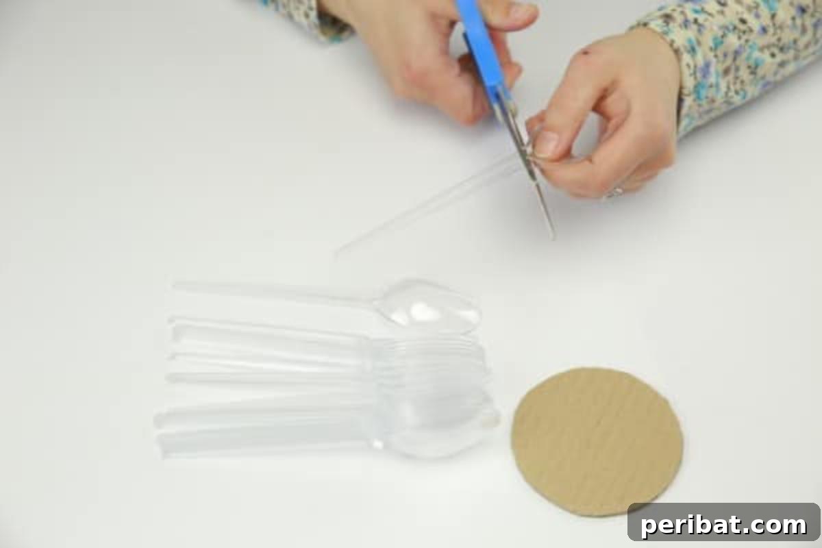 Carefully cutting handles off plastic spoons for crafting