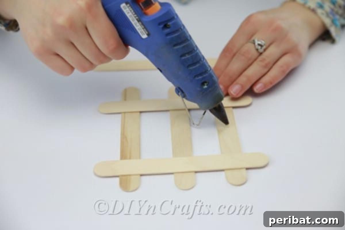 Stick-tacular Creations: 3 Crafts for Every Generation 14 Gluing down intersecting popsicle sticks for coaster construction