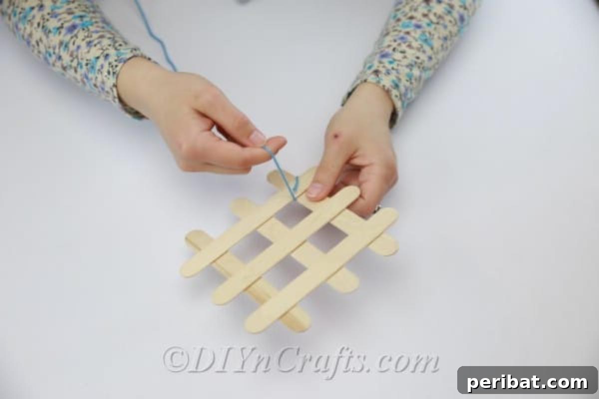 Stick-tacular Creations: 3 Crafts for Every Generation 15 Wrapping yarn around the corners where popsicle sticks meet on a coaster