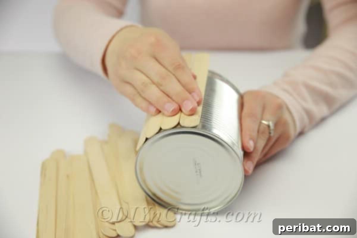 Stick-tacular Creations: 3 Crafts for Every Generation 20 Covering the entire empty can with popsicle sticks in a continuous pattern