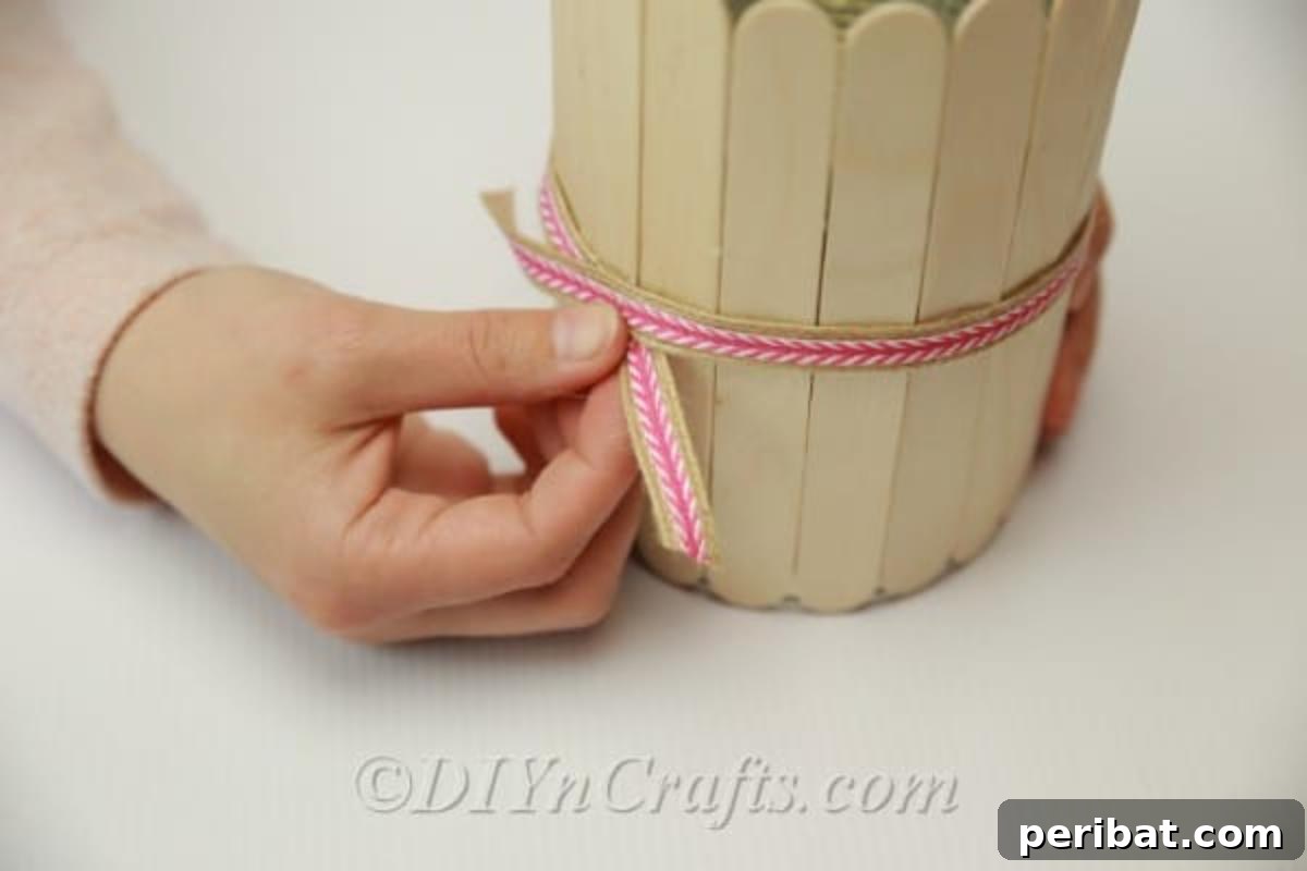 Stick-tacular Creations: 3 Crafts for Every Generation 21 Adding decorative ribbon to the outside of the popsicle stick pencil holder
