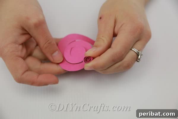 A perfectly cut paper swirl, forming a continuous strip that spirals inward to a central point.