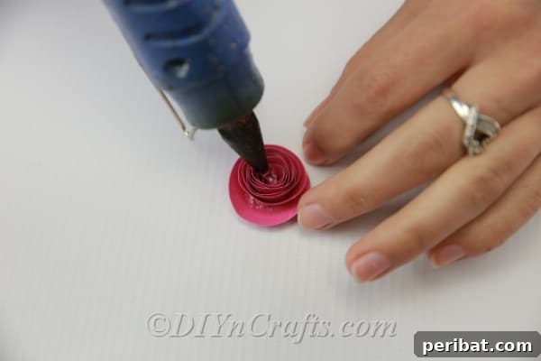 Several decorative paper flowers of varying sizes and colors, showcasing different embellishments.