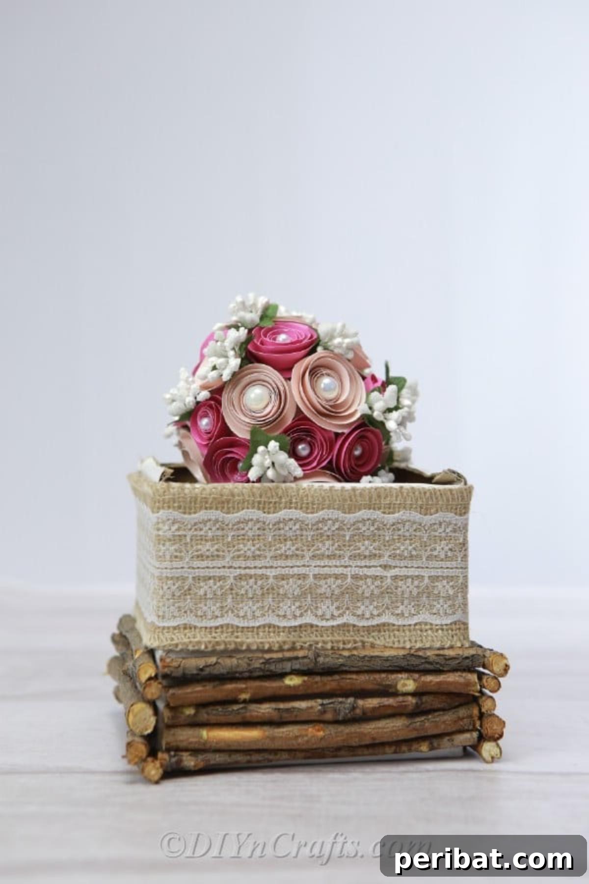 Beautifully arranged paper flower ball displayed on a decorative box, ideal for weddings or enhancing home decor.