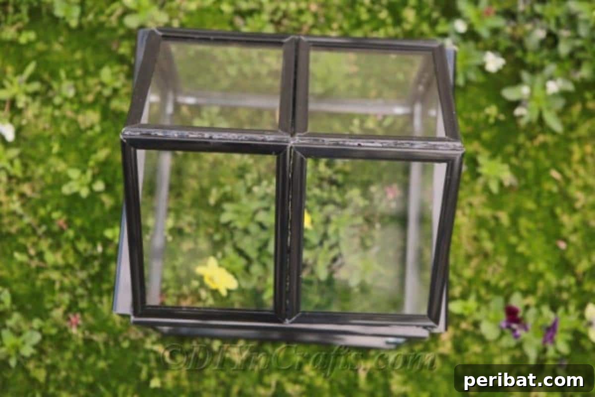 Repurpose Old Picture Frames Into A Delightful Mini Greenhouse 3 Partially assembled picture frame greenhouse, showing the base constructed from four large frames without the roof, ready for the next step.