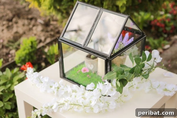 How To Make A Miniature Greenhouse From Picture Frames - A finished mini greenhouse made from picture frames, decorated with small plants.