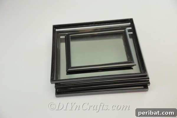 Stack of picture frames of different sizes, ready for use in building a DIY greenhouse.