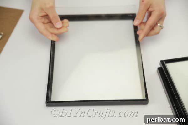A cleaned picture frame without its cardboard backing, ready for painting or assembly.