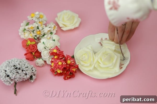 Craft a Magical Floating Teacup Ornament 12 Applying more hot glue to attach artificial flowers onto the saucer