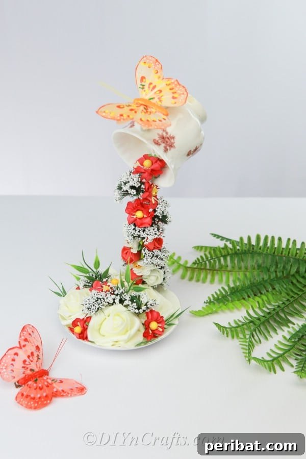 Craft a Magical Floating Teacup Ornament 15 The completed floating teacup decoration overflowing with artificial flowers