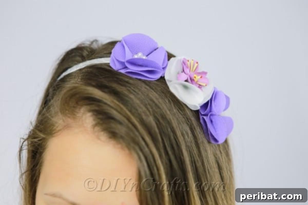 Craft a Beautiful Fabric Flower Headband 2 A charming DIY flower headband adorned with an array of purple and white fabric flowers, offering a beautiful and versatile hair accessory for any occasion.