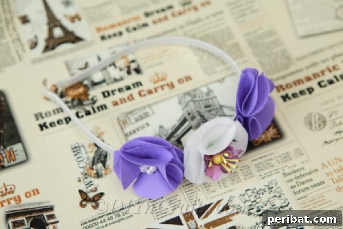 Craft a Beautiful Fabric Flower Headband 4 A beautifully completed fabric flower headband carefully placed on a newspaper-covered surface, highlighting the vibrant colors and sturdy construction.