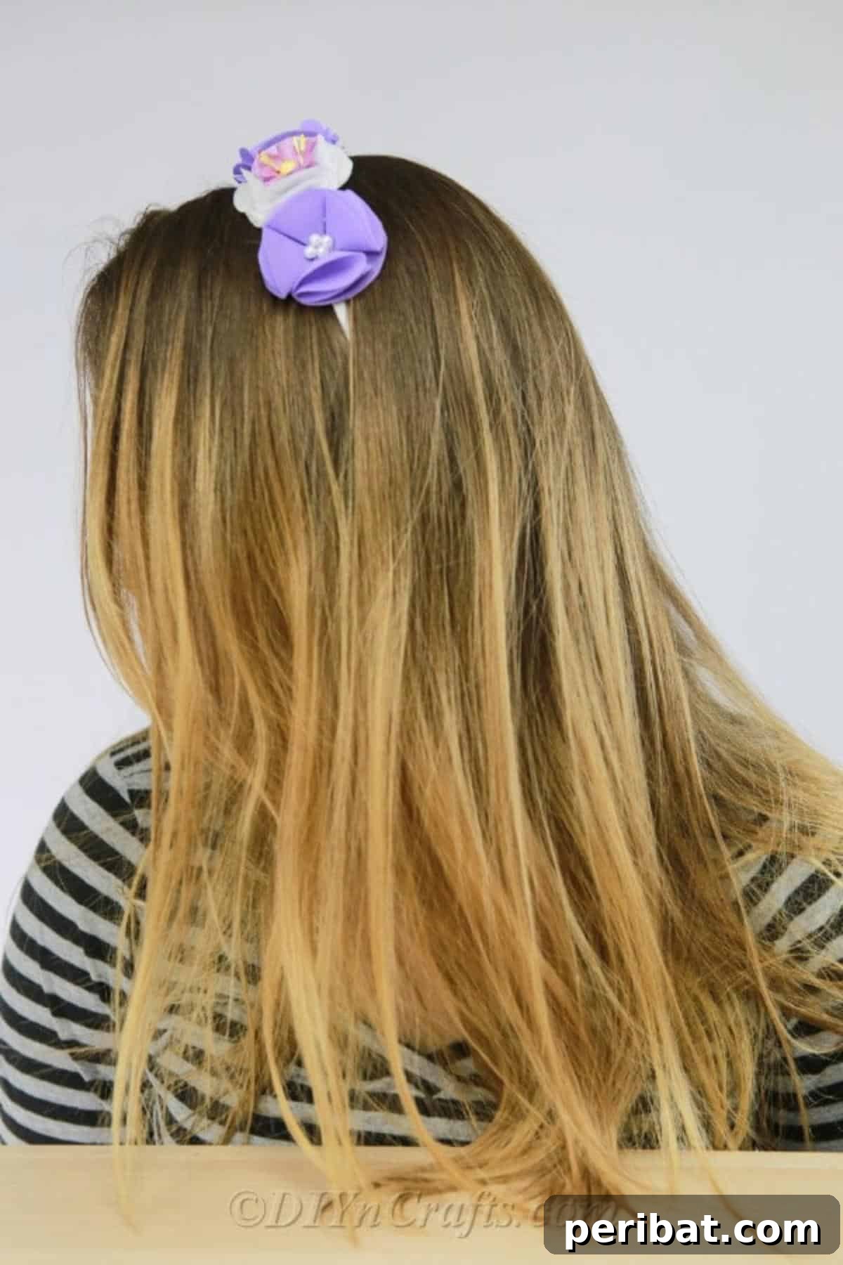 Craft a Beautiful Fabric Flower Headband 5 A joyful young girl models a handmade fabric flower headband, showcasing how stylish and comfortable the accessory is for children.