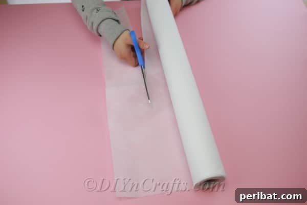 A pen being used to trace uniform circles onto a piece of fabric, guided by a round object, to prepare for cutting flower petals.