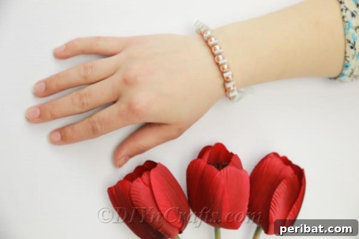 Crafting a Pearl and Ribbon Bracelet 3 Handmade pearl and ribbon bracelet next to tulips