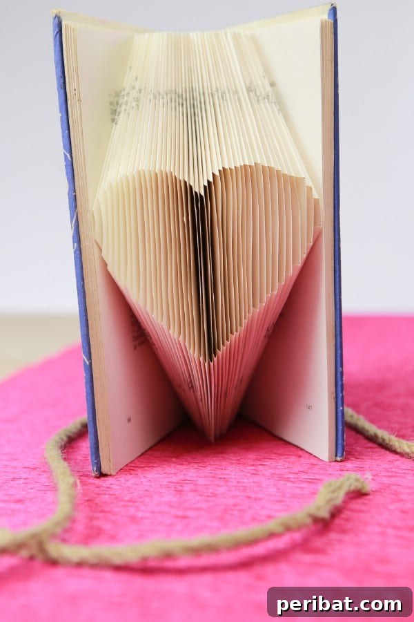 DIY Heart Shaped Book Folding Video Tutorial - Learn how to turn an old book into a work of art with this book page folding tutorial. Create a heart shape with those pages to display your book anywhere beautifully.