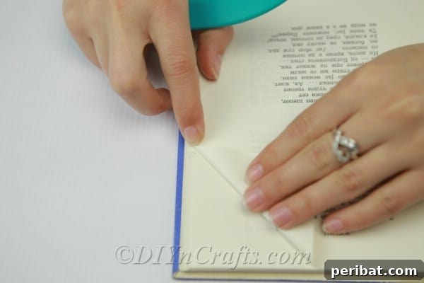 Demonstration of folding down the top corner of a book page to the first mark.