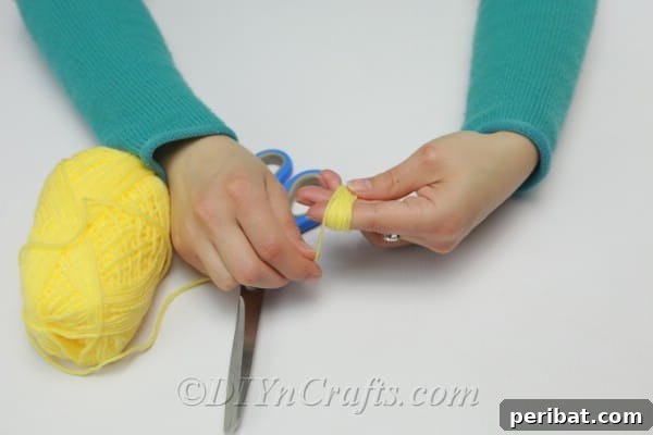 DIY Rope Baskets Elevate Your Storage Style 12 Wrapping yarn around two to three fingers to create the body of a DIY tassel.