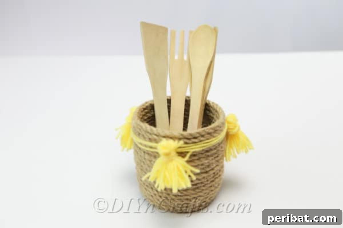 DIY Rope Baskets Elevate Your Storage Style 3 Rustic rope basket filled with wooden kitchen utensils, showcasing its utility as a stylish storage solution.
