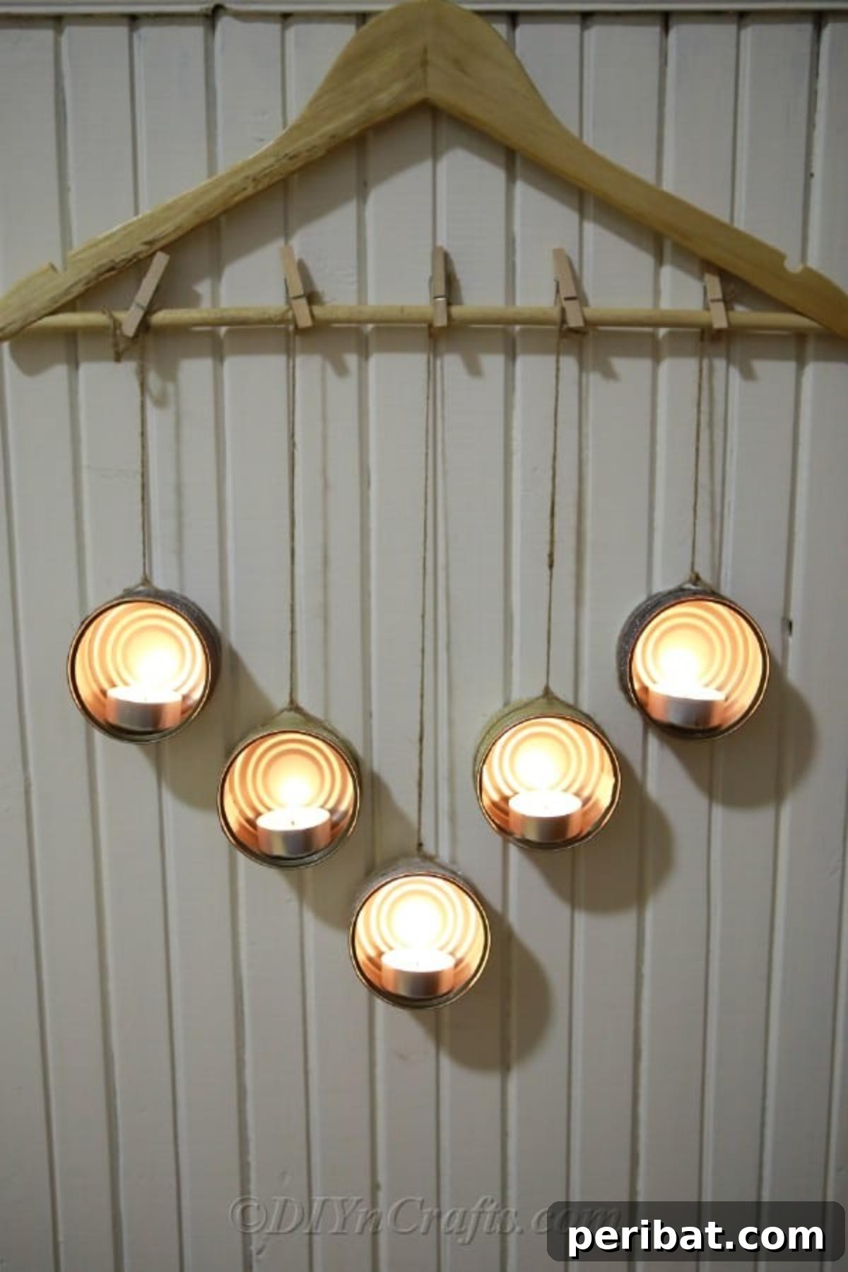 Transform Tuna Cans into Pretty Tealight Holders 3 Decorated tuna can tealight holders with lit candles, showcasing a warm and inviting atmosphere.
