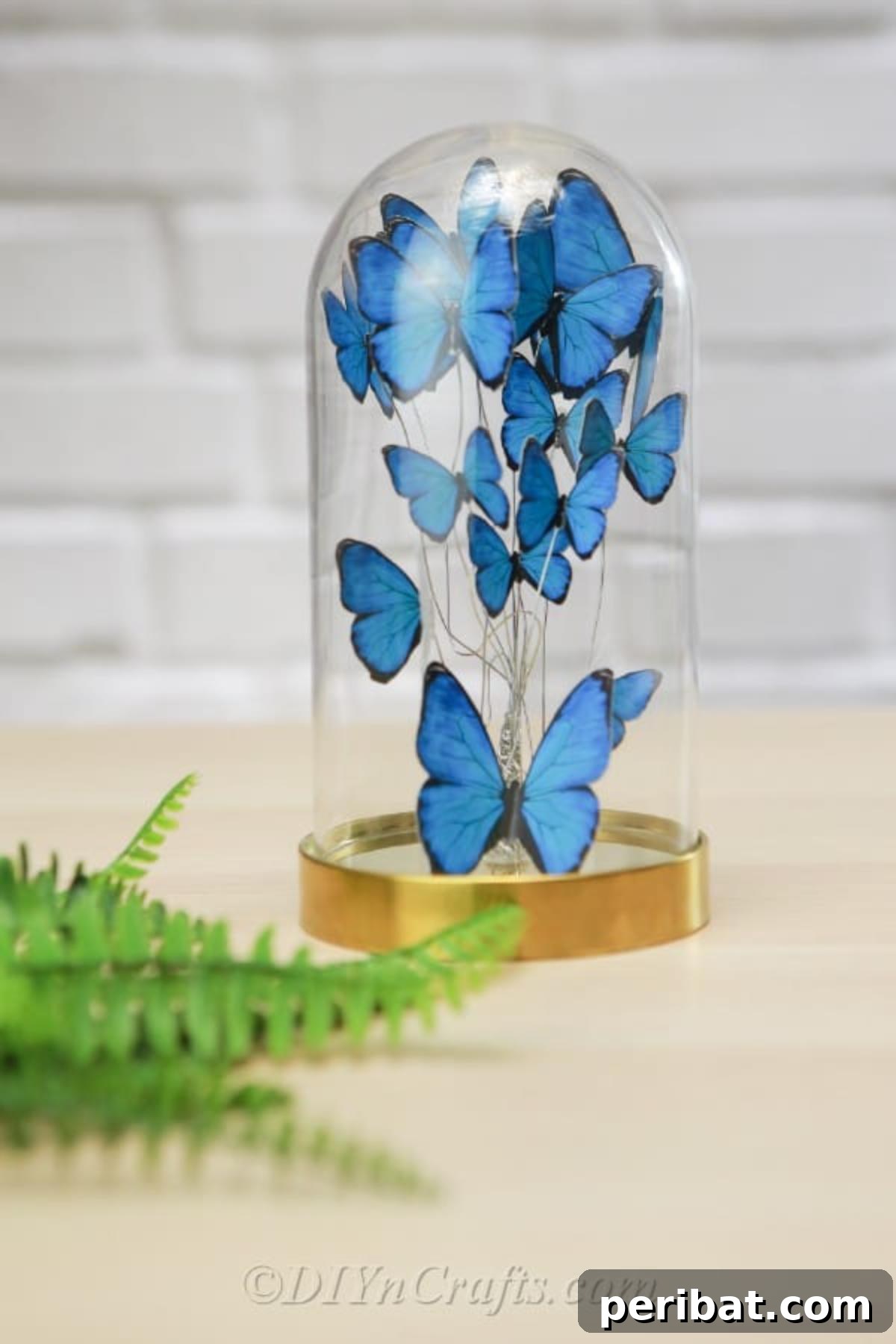 Crafting an Enchanting Butterfly Jar Terrarium 2 A stunning DIY butterfly jar adorned with vibrant blue paper butterflies, serving as a charming piece of home decor.