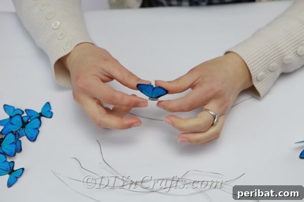Crafting an Enchanting Butterfly Jar Terrarium 11 Demonstration of gluing paper butterflies onto cut pieces of craft wire for suspension.