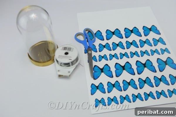 Supplies needed to make a DIY butterfly jar, including paper butterflies, wire, and a glass jar.