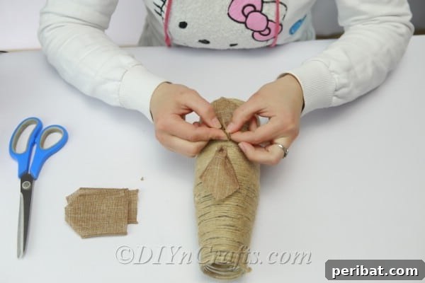Assembling a layered flower design using burlap ribbon, showing the process of combining different widths and textures.