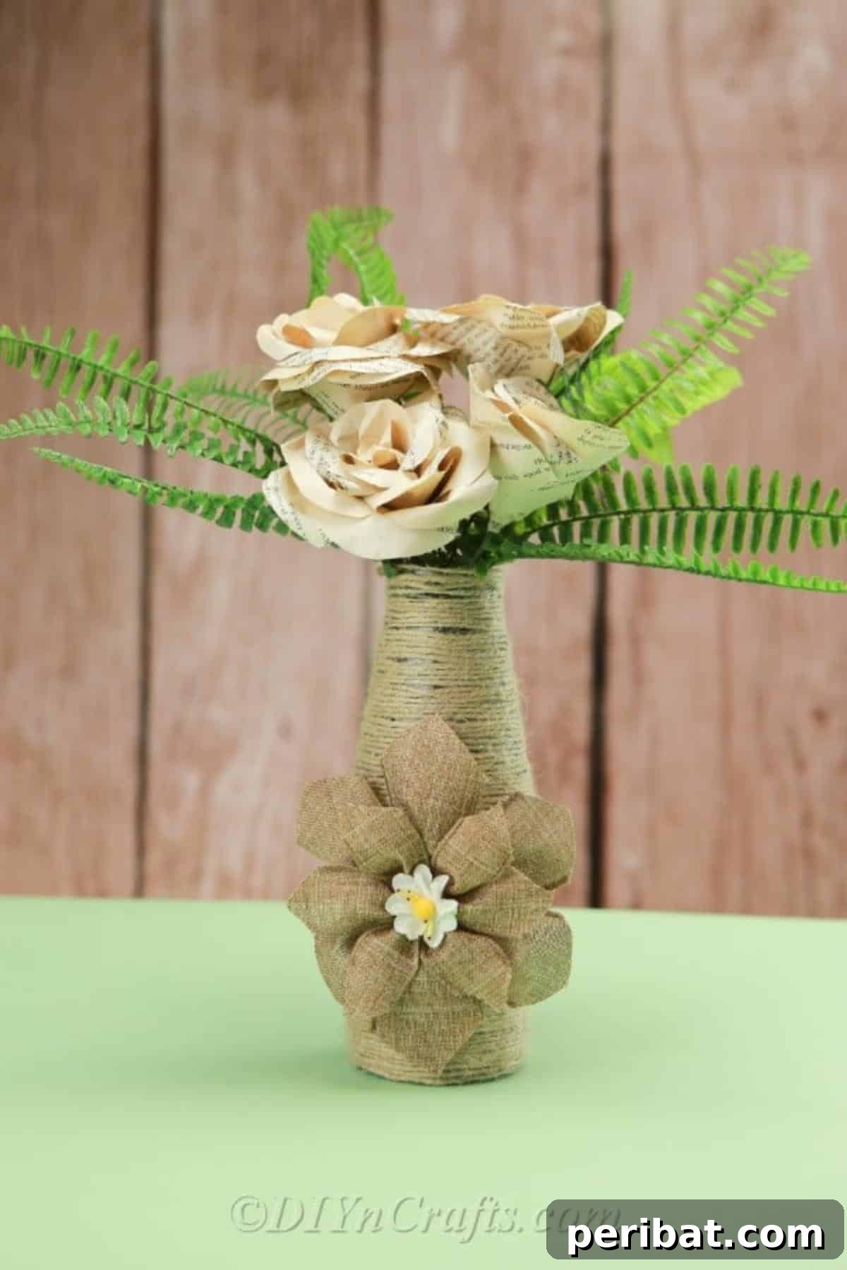 Rope Wrapped Bottles for Rustic Charm 5 Rope-covered vase displaying lush green foliage, emphasizing its natural aesthetic and versatility for various plant arrangements.