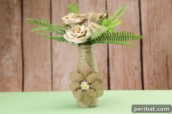 A beautifully crafted rustic rope-covered bottle vase, perfect for adding farmhouse charm to any interior.