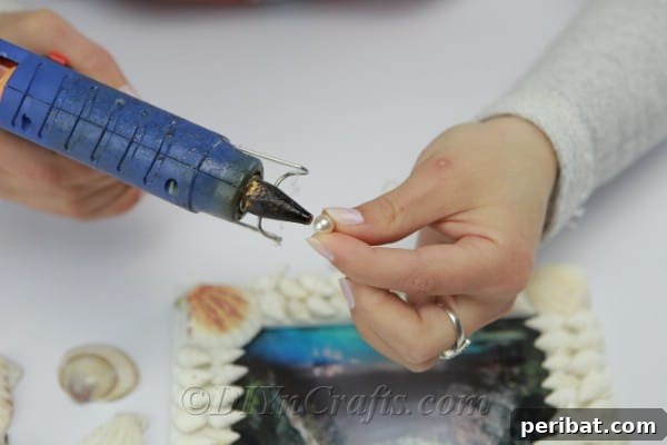 Hot gluing shells onto a picture frame