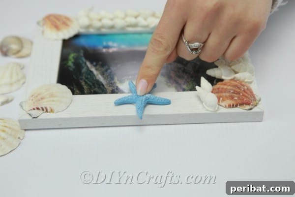 Adding decorations to finished seashell picture frame
