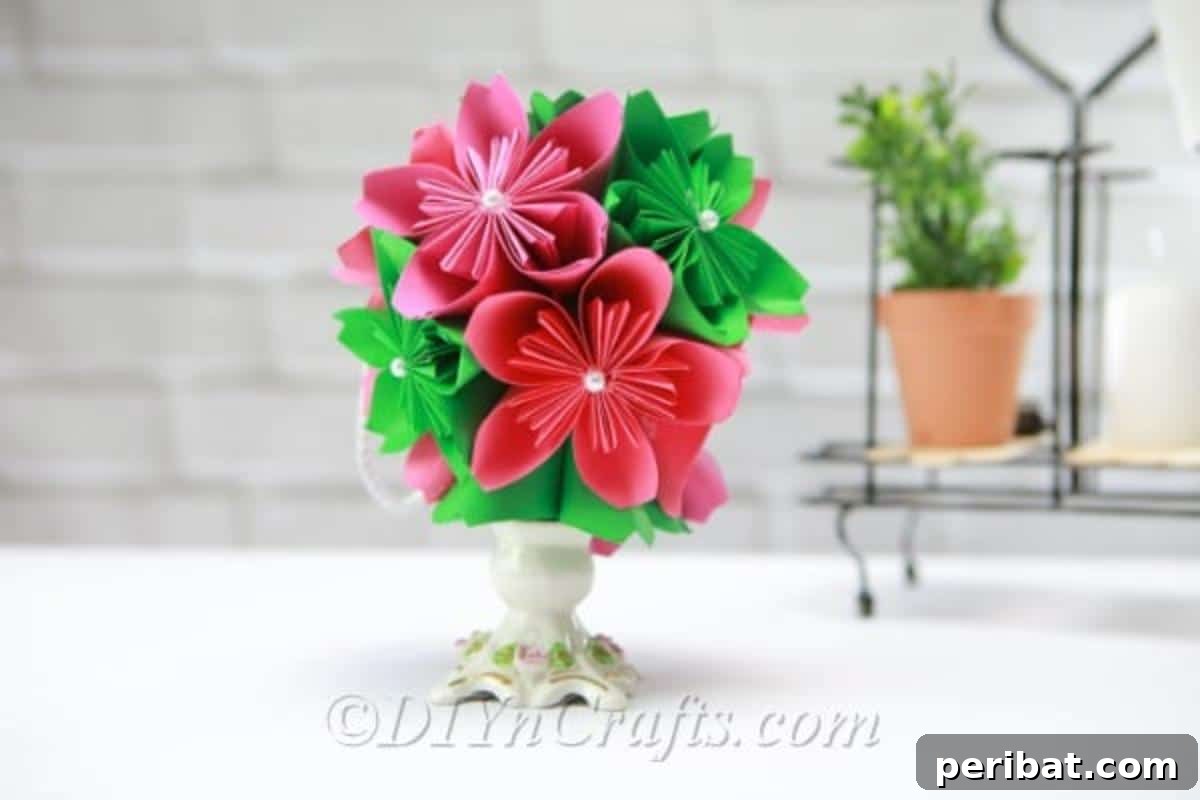 Pink and green paper flower ball in a vase, showcasing a charming handmade decoration