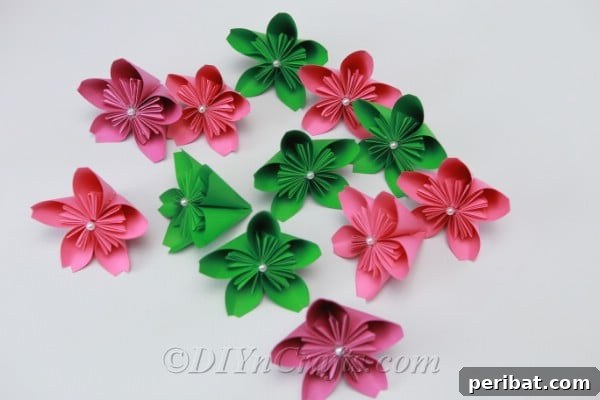 A vibrant collection of pink and green paper flowers, showcasing various color combinations