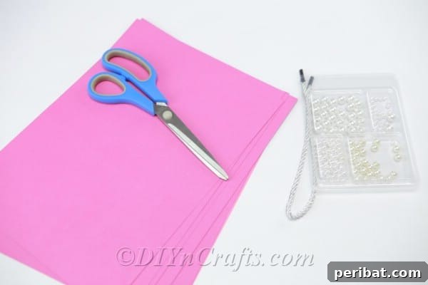 Collection of colored paper sheets and crafting supplies ready for flower ball creation