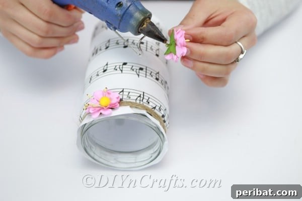 Adding artificial flowers to decorate a music sheet jar, enhancing its beauty