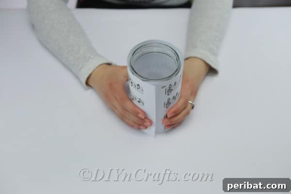 Wrapping sheet music around a clean glass jar