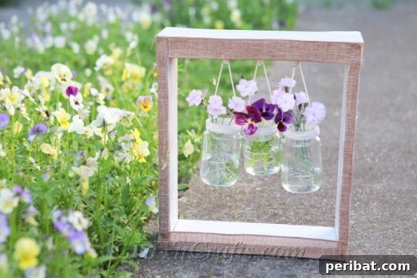 A finished DIY wooden box vase hanger with multiple glass jars, each holding colorful flowers, suspended elegantly for a charming rustic home decor display.