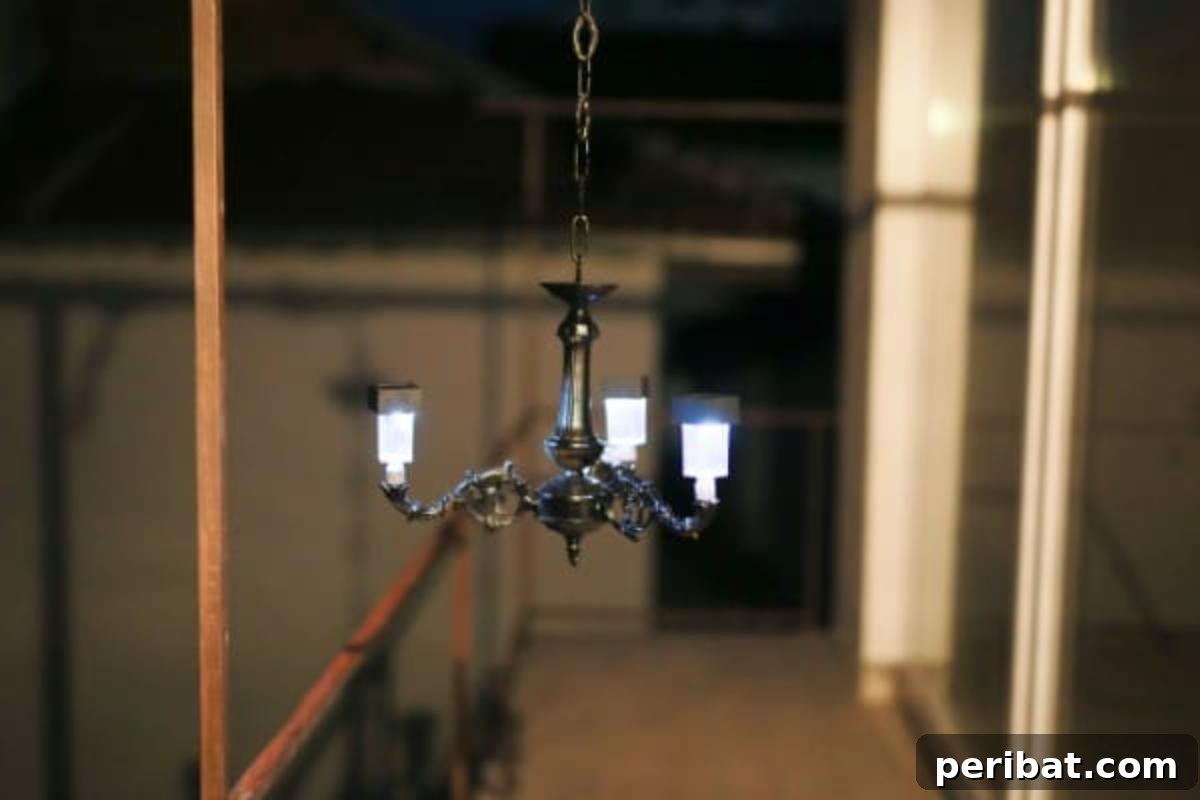 Stunning DIY solar chandelier lit up at night, casting a warm glow over an outdoor space.