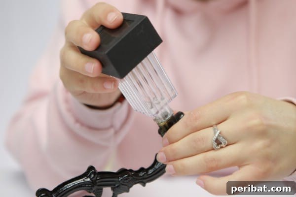 One single solar light being prepared for attachment to a chandelier, with its stake removed