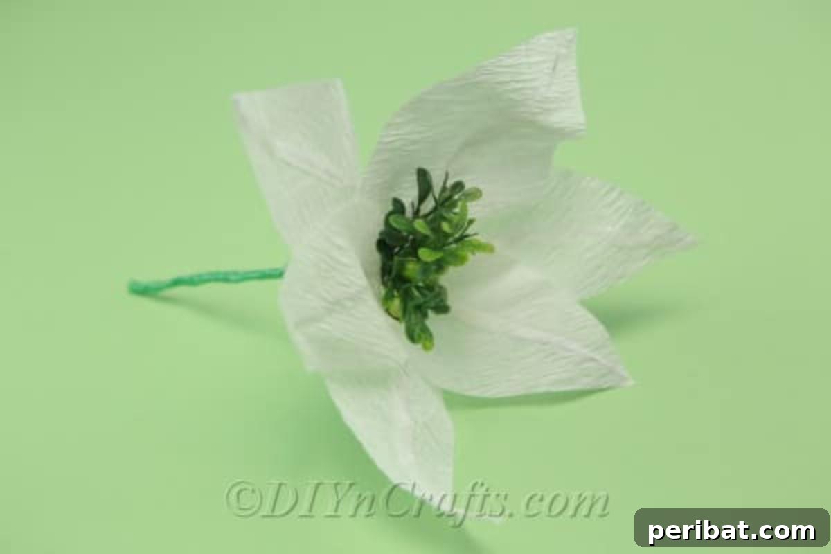 A beautifully finished white tissue paper flower, showcasing its delicate petals and elegant form.