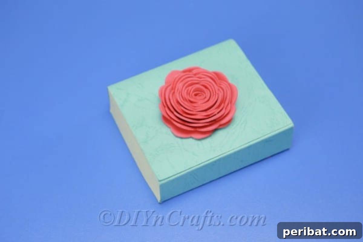A vibrant pink foam flower adorning a gift box, demonstrating its use as a charming decoration.