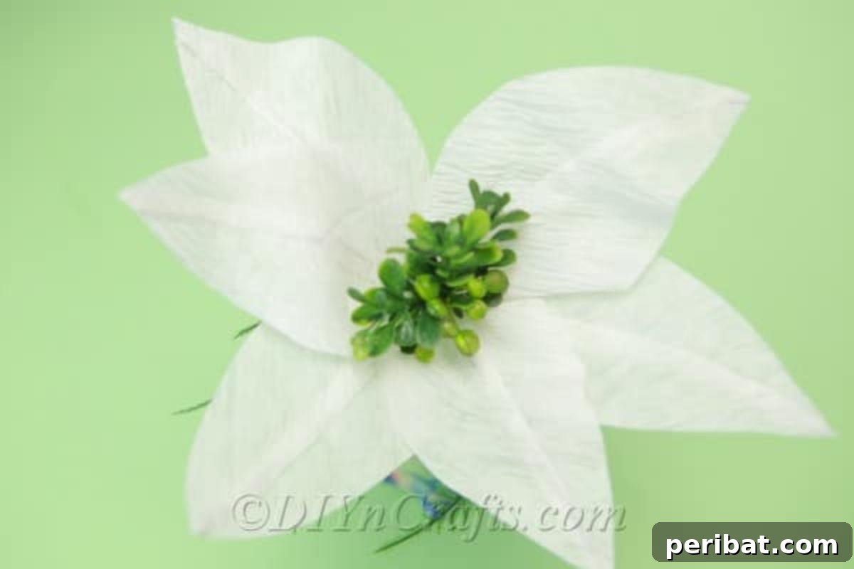 A beautiful tissue paper flower carefully placed in a simple vase, ready for display.