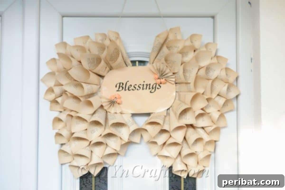 Literary Angel Wings Decor 2 Delicate book page angel wings decoration hanging gracefully on a white door, embodying serene home decor.