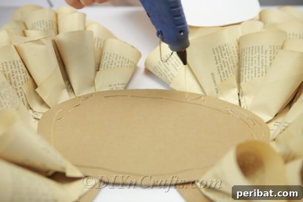 Literary Angel Wings Decor 15 Gluing the cardboard oval onto the cone-covered wings to join them