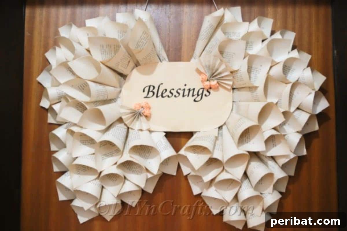 Literary Angel Wings Decor 3 Close-up of elegant book page angel wings hanging on a rustic wooden door, showcasing the intricate detail of the craft.